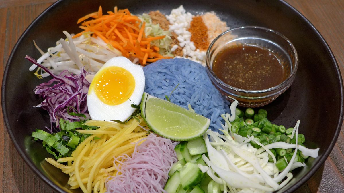 A bowl filled with all sorts of colorful ingredients.