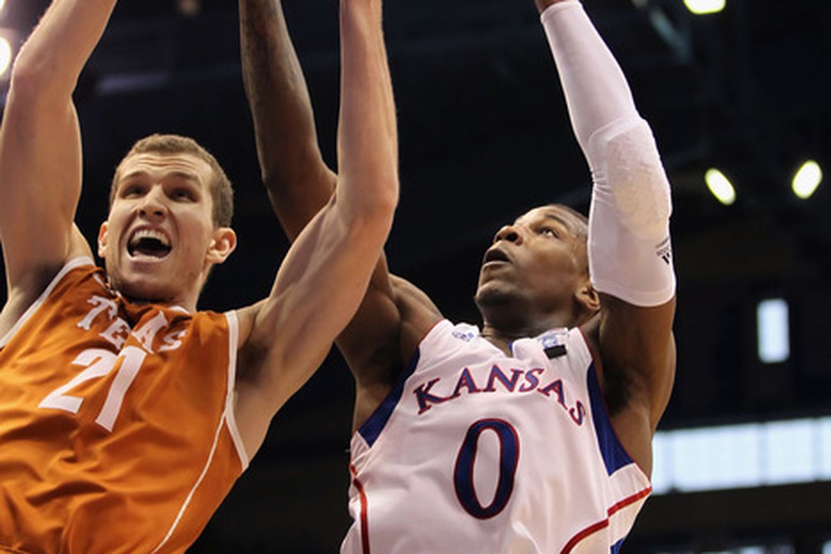 LAWRENCE KS - JANUARY 22:  Matt Hill #21 of the Texas Longhorns grabs a rebound over Thomas Robinson #0 of the Kansas Jayhawks during the game on January 22 2011 at Allen Fieldhouse in Lawrence Kansas.  (Photo by Jamie Squire/Getty Images)