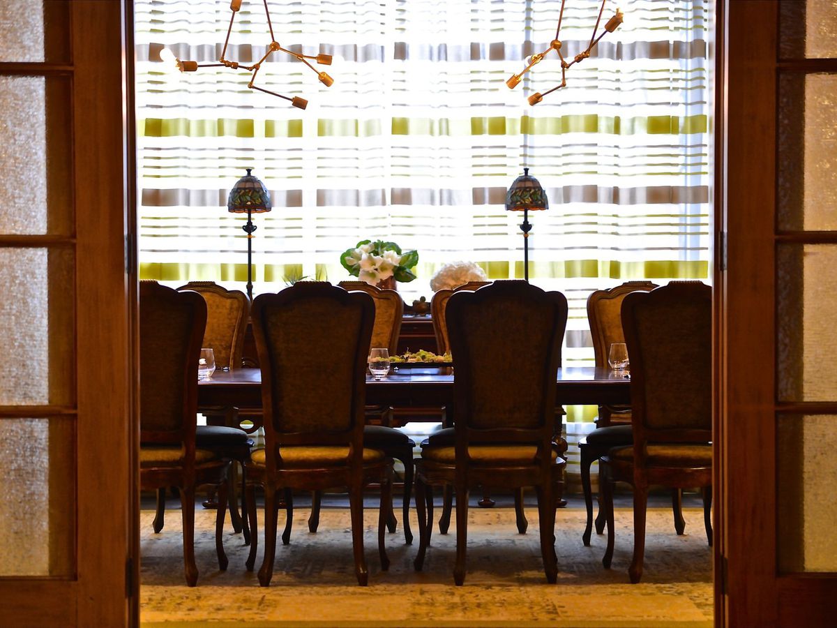 A restaurant’s private dining room is seen through open doors.