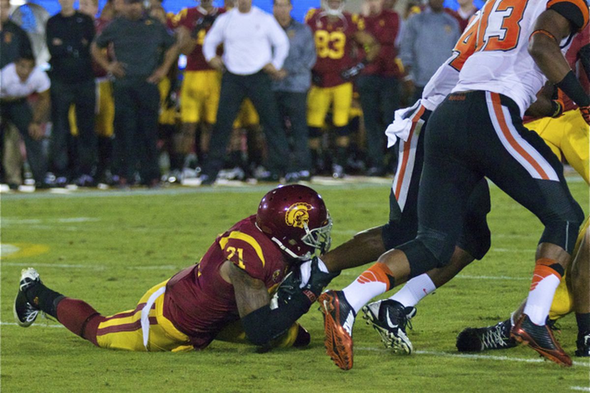 Su'a Cravens grabs a running back behind the line.