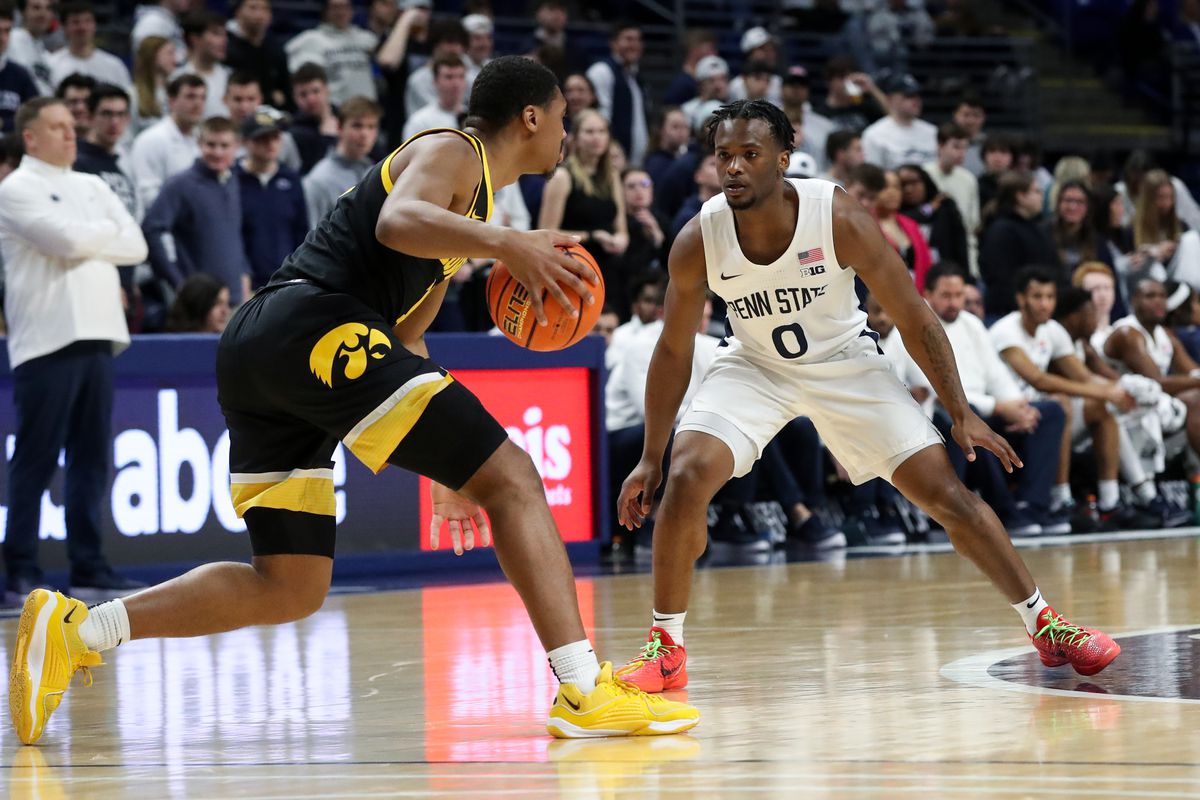 Penn State Nittany Lions guard Kanye Clary (0) defends as Iowa Hawkeyes guard Tony Perkins (11) dribbles the ball down court during the first half at Bryce Jordan Center. Penn State defeated Iowa 89-79.