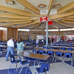 People visit the cafeteria at the old Granger High School on Saturday, June 1, 2013, in West Valley City. The school is scheduled to be demolished.