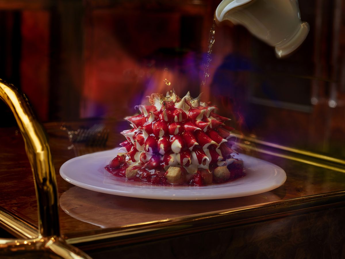 A red dessert with spikes on a cart
