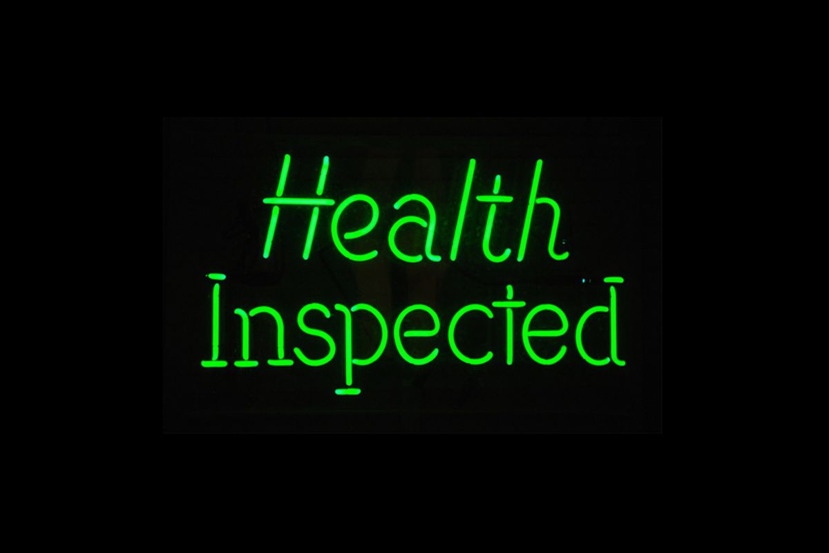 Neon sign that says “health inspected”