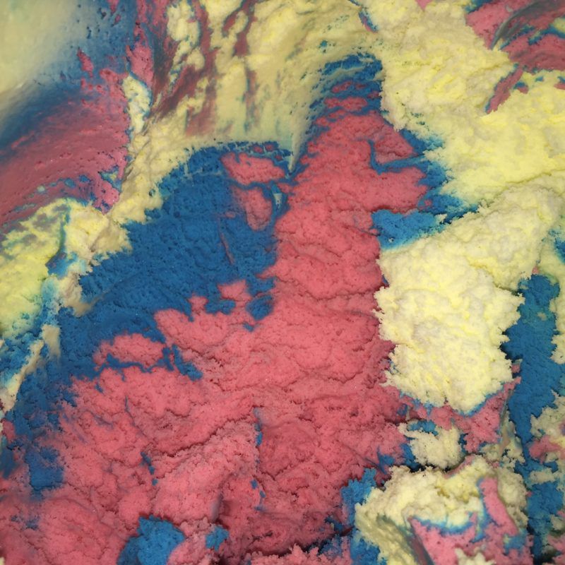 Superman ice cream comes in blue, red and yellow and is swirled.