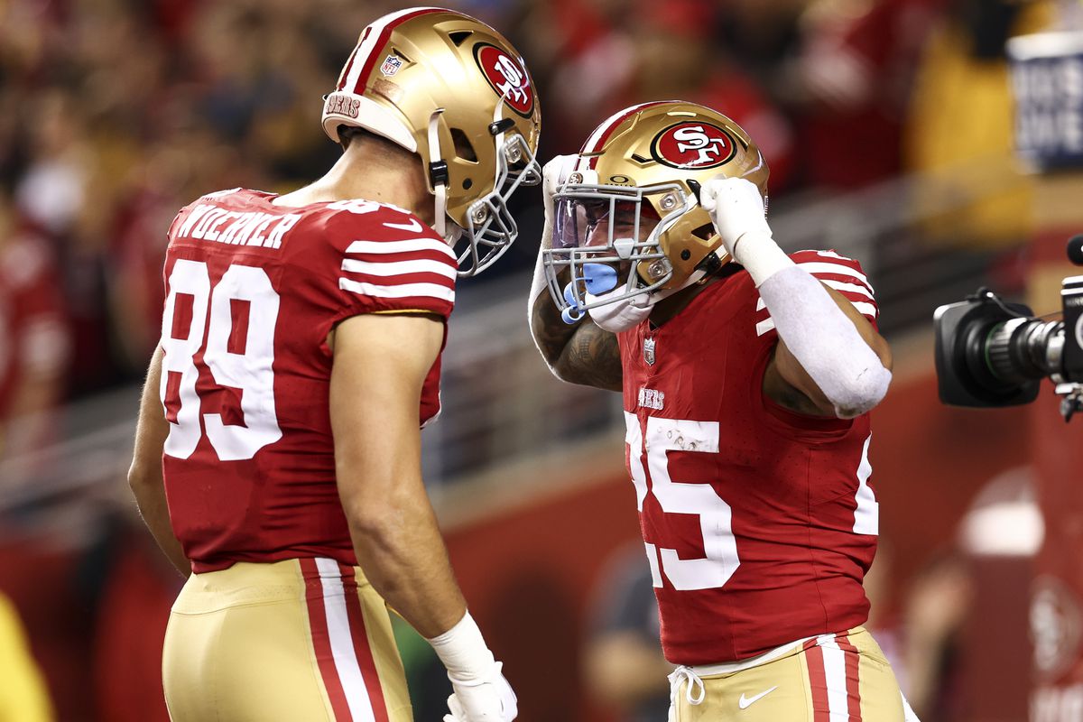 Elijah Mitchell #25 of the San Francisco 49ers celebrates with Charlie Woerner #89 after scoring a touchdown during the NFC Championship NFL football game against the Detroit Lions at Levi’s Stadium on January 28, 2024 in Santa Clara, California.