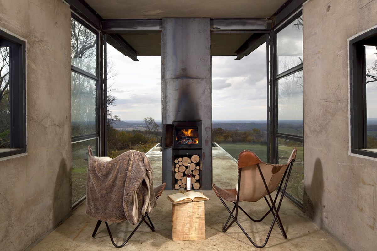 Chairs facing wood burning stove and windows