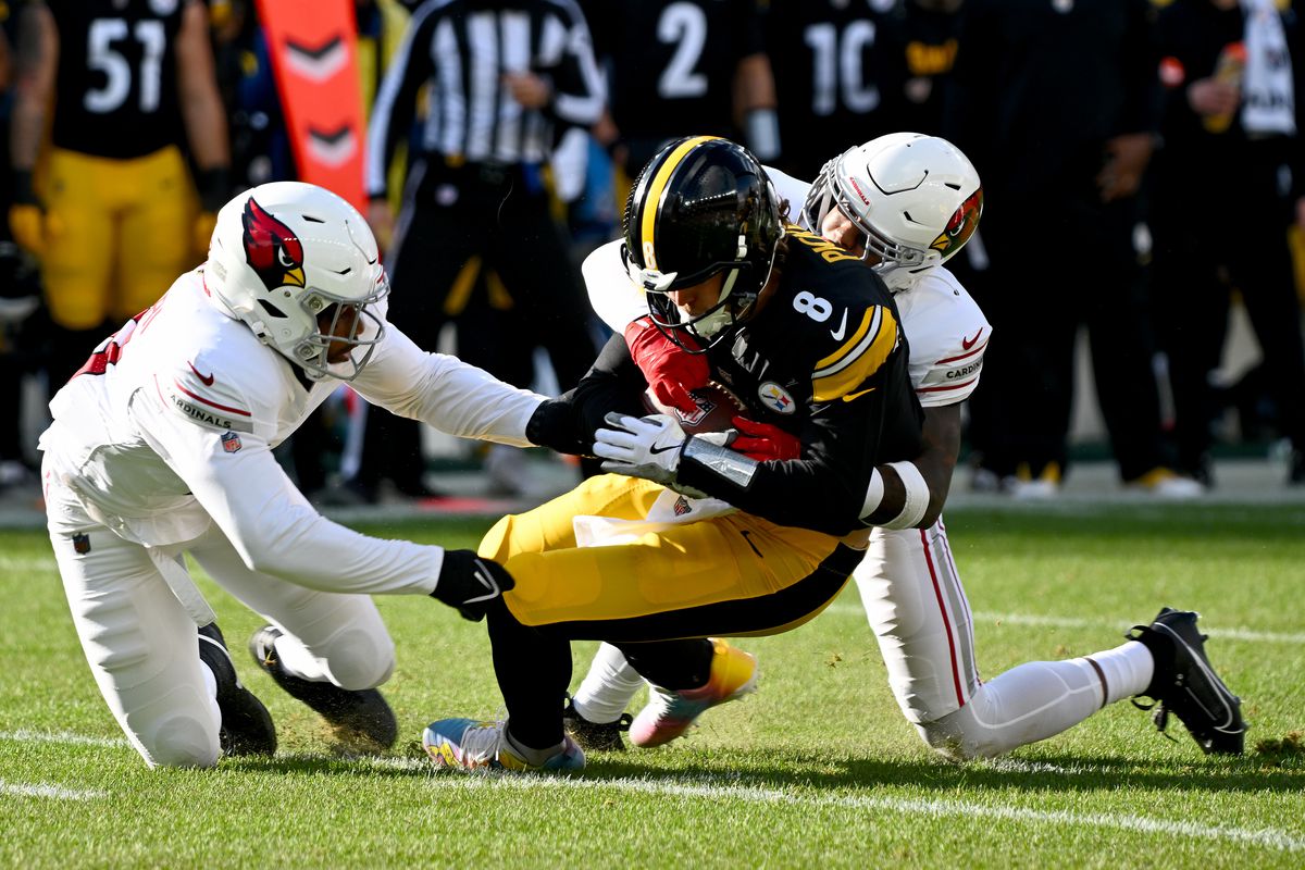 Kenny Pickett #8 of the Pittsburgh Steelers is tackled by Budda Baker #3 of the Arizona Cardinals during the first quarter at Acrisure Stadium on December 03, 2023 in Pittsburgh, Pennsylvania.