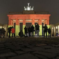 The Brandenburg Gate is illuminated in the colors of the German flag in Berlin, Germany, Tuesday, Dec. 20, 2016, the day after a truck ran into a crowded Christmas market and killed several people. 
