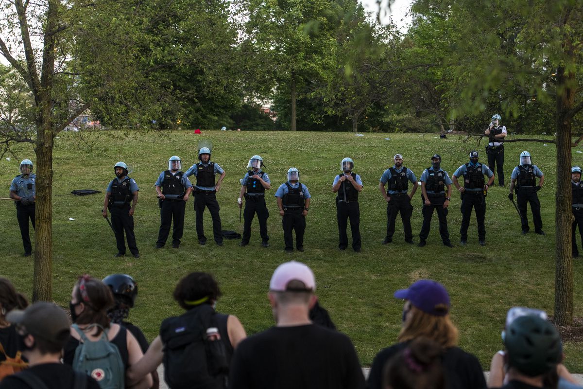 Chicago police and protesters face off in Grant Park after protesters attempted to topple a Christopher Columbus Statue located at Roosevelt and Columbus on Friday.