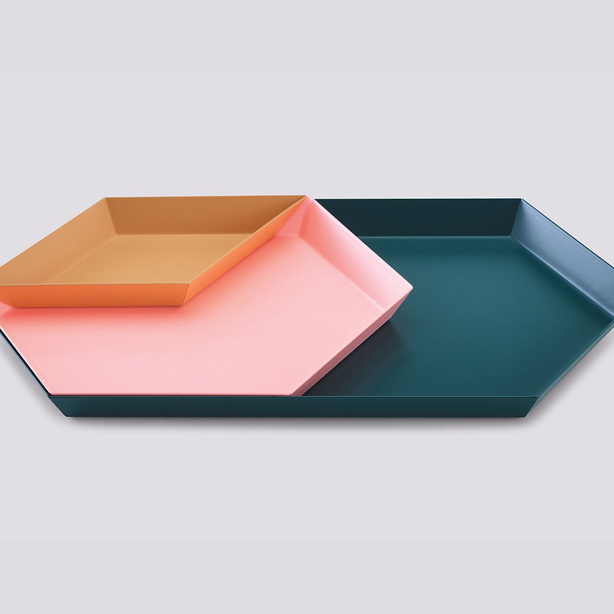 A set of three colorful and geometric-shaped trays. Ranging from small to large, the trays are stacked on top of each other.  