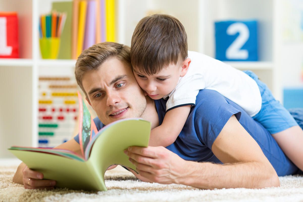 A father reads to his son.