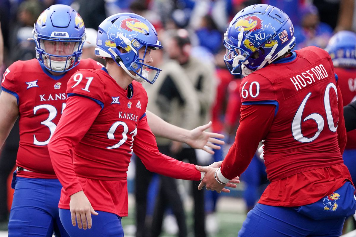 Nov 11, 2023; Lawrence, Kansas, USA; Kansas Jayhawks place kicker Seth Keller (91) celebrates with long snapper Luke Hosford (60) after kicking a field goal against the Texas Tech Red Raiders to tie the game during the second half at David Booth Kansas Memorial Stadium.