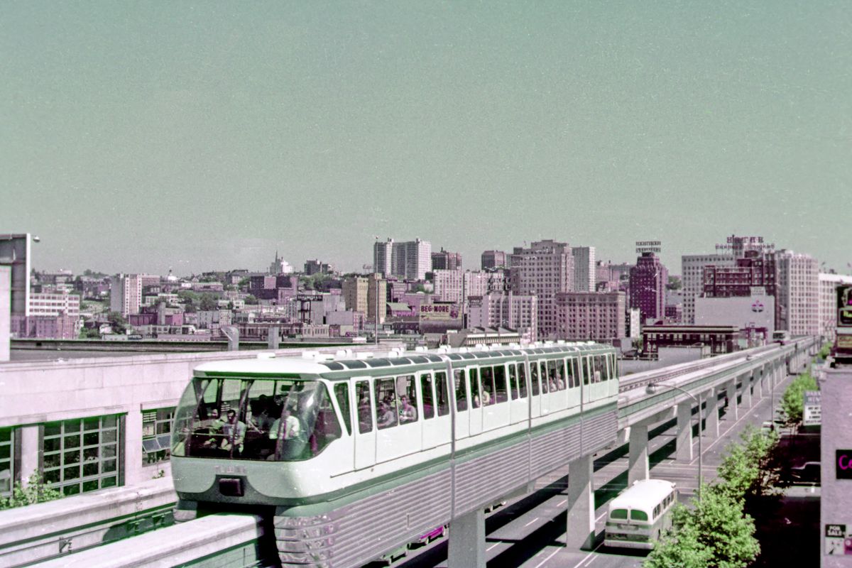 The monorail is pictured in an early color photograph, with heavy pink and green pigmentation.