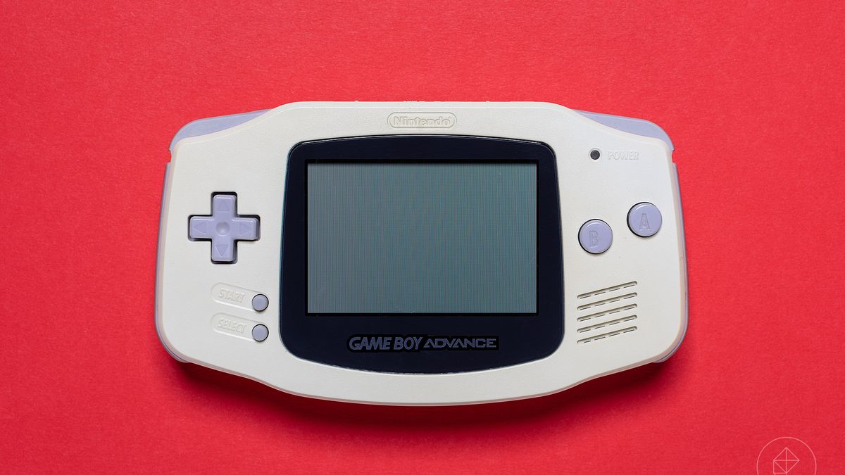 A Game Boy Advance sitting against a red background