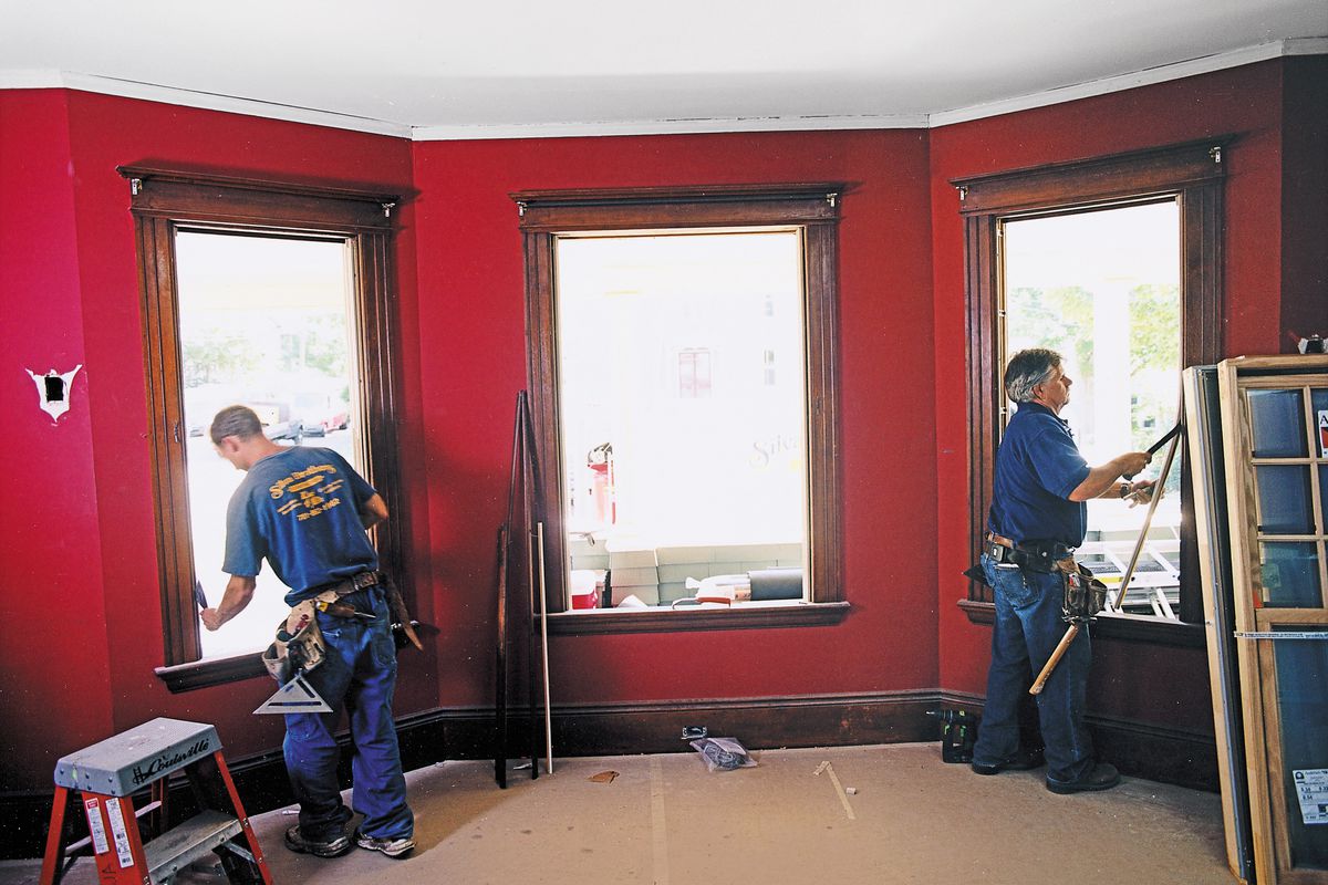 Men Installing New Windows To Replace Old Windows