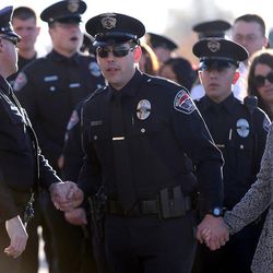 A West Valley police officer arrives at the funeral of officer Cody Brotherson at the Maverik Center in West Valley City on Monday, Nov. 14, 2016.