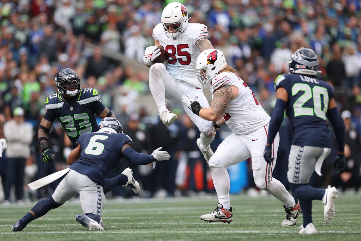 Trey McBride of the Arizona Cardinals carries the ball during the fourth quarter of the game against the Seattle Seahawks at Lumen Field on October 22, 2023 in Seattle, Washington.