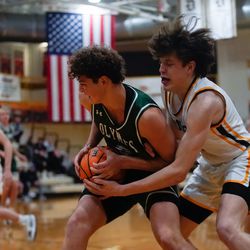 Olympus’ Anthony Olsen, left, guards the ball against Davis’ Henry Ihrig as they compete in the Northern Utah Shootout championship game at Davis High School in Kaysville on Saturday, Dec. 11, 2021.
