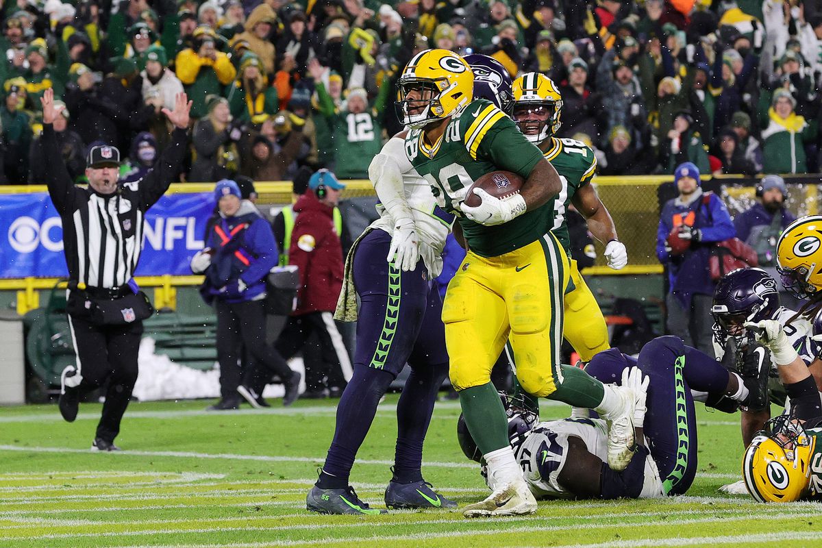 A.J. Dillon #28 of the Green Bay Packers scores a touchdown against the Seattle Seahawks during the fourth quarter at Lambeau Field on November 14, 2021 in Green Bay, Wisconsin.