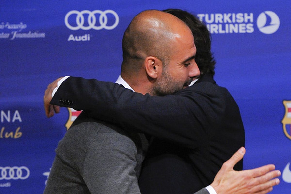 Guardiola at his last presser as Barca manager hugs President Sandro Rosell