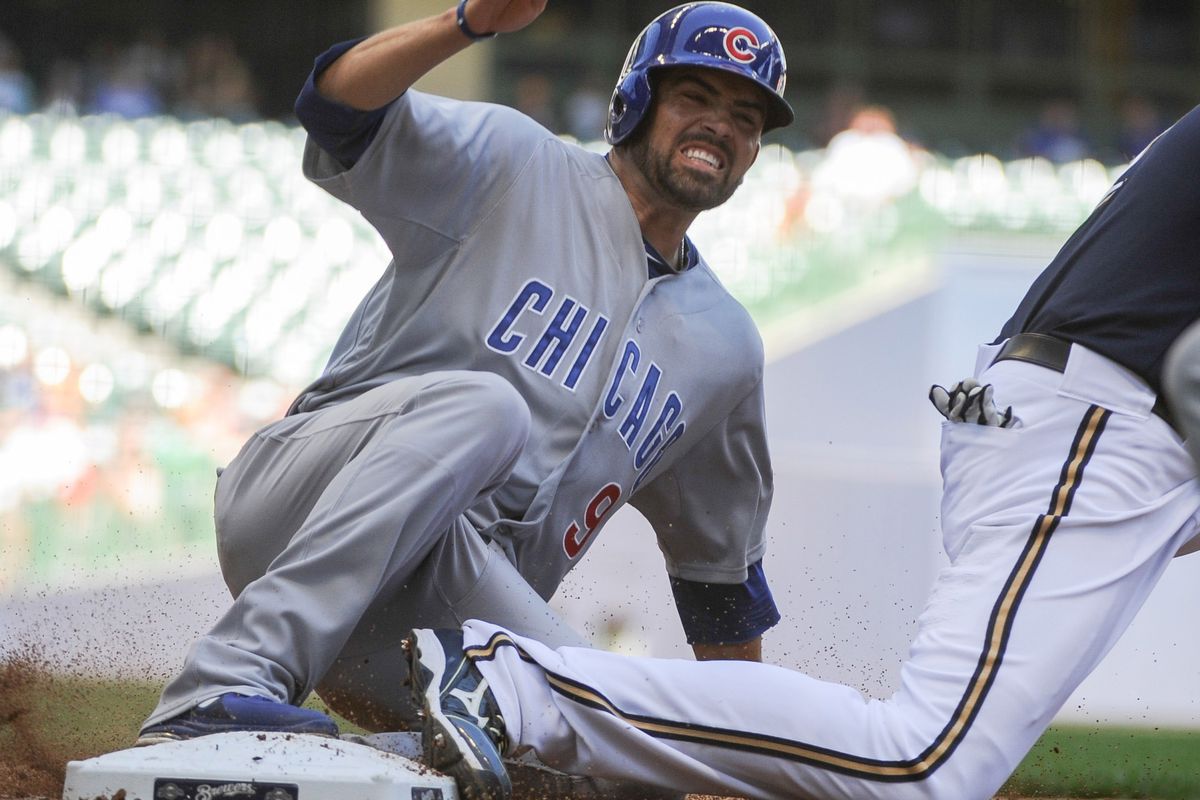 Milwaukee, WI, USA; Chicago Cubs right fielder David DeJesus gets back to first base safely after a flyout by third baseman Luis Valbuena against the Milwaukee Brewers at Miller Park. Credit: Benny Sieu-US PRESSWIRE