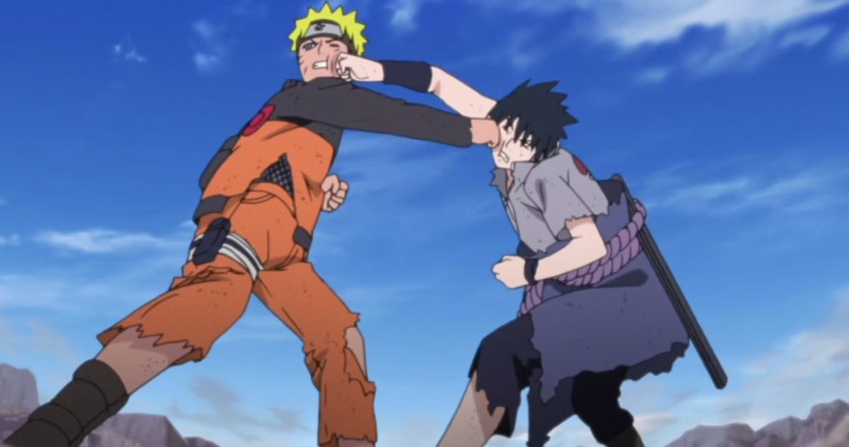 A blond-haired anime boy (Naruto) wearing a metal headband and an orange tracksuit exchanging blows with a dark-haired anime boy (Sasuke) in a gray and purple uniform in 2007’s Naruto: Shippuden.