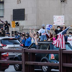 People cheer as cars pass by North Michigan Avenue and East Wacker Drive in the Loop to celebrate President-elect Joe Biden’s victory, Saturday afternoon, Nov. 7, 2020.