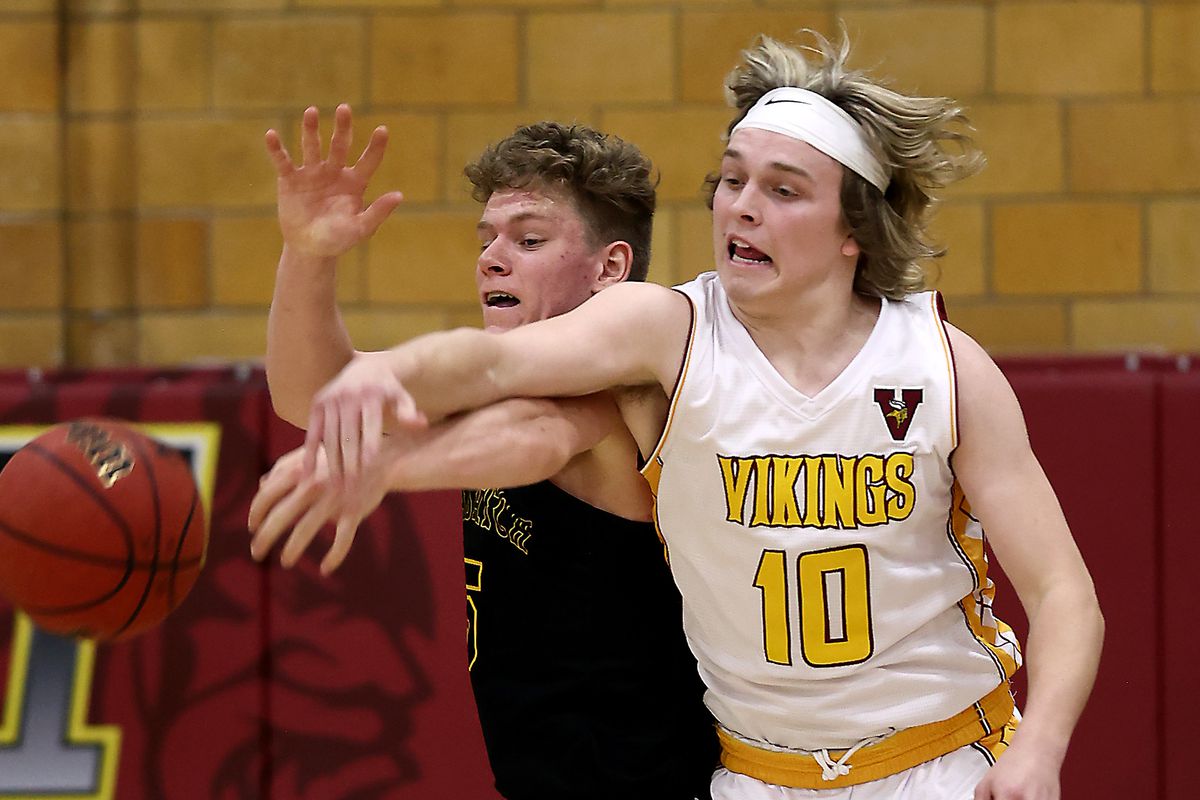 Viewmont’s Carson Williams battles Wasatch’s Jaxton Anderson for the ball as they play in first round basketball action at Viewmont in Bountiful on Wednesday, Feb. 24, 2021.
