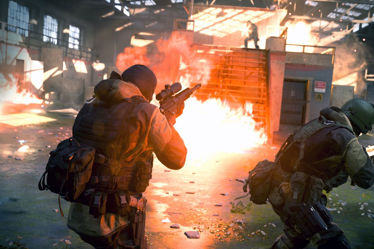 Four players engage in a firefight in a warehouse in a screenshot from Call of Duty: Modern Warfare’s new Gunfight mode.