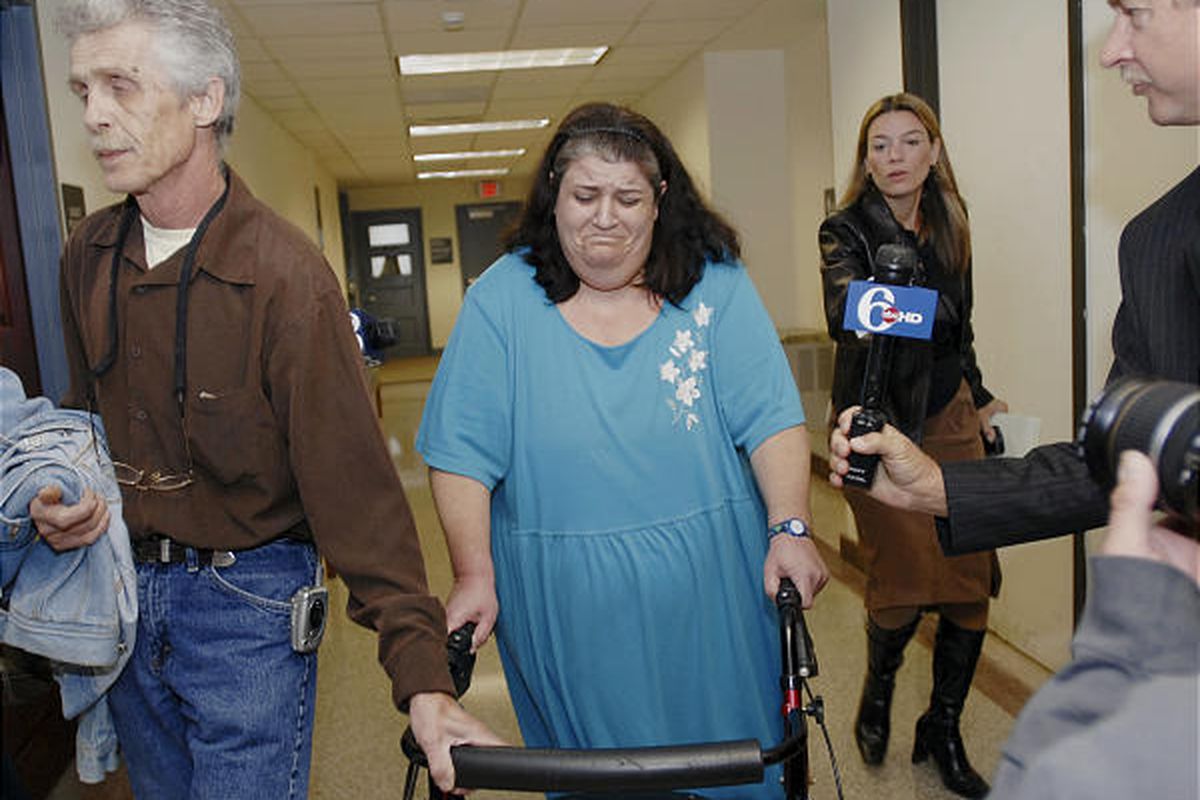Michele Cossey, center, and her husband, Frank Cossey, left, arrive at the Montgomery County Courthouse in Norristown, Pa., on Friday. Their 14-year-old son Dillon Cossey was charged as a juvenile with solicitation to commit terror.