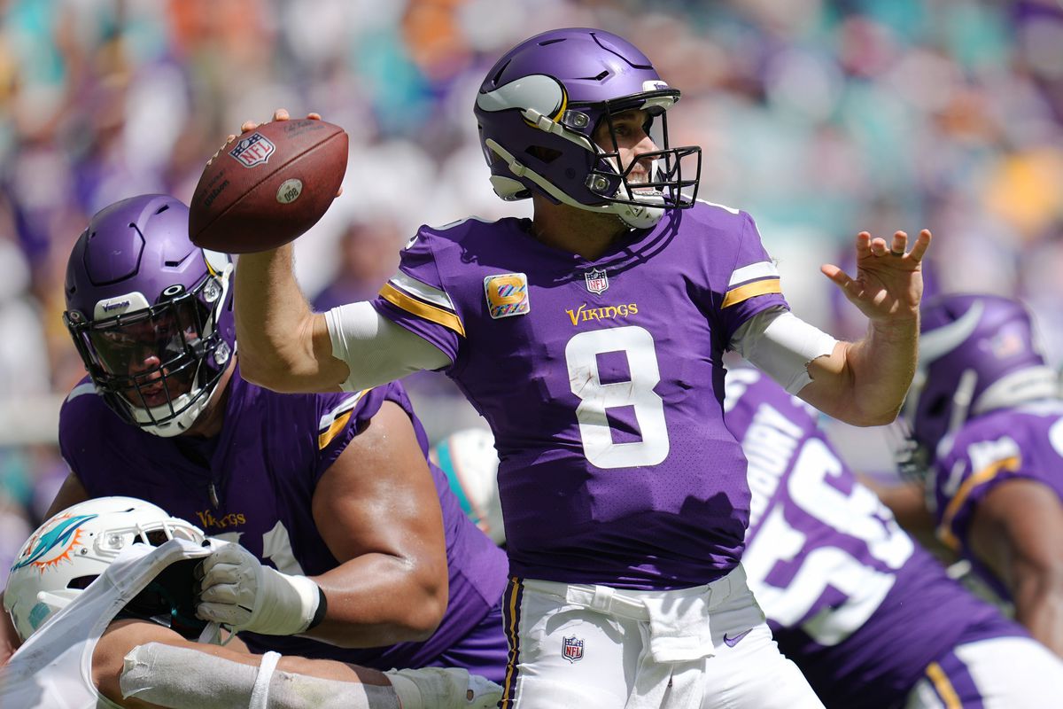 Minnesota Vikings quarterback Kirk Cousins (8) drops back to pass against the Miami Dolphins during the first half of an NFL game at Hard Rock Stadium in Miami Gardens