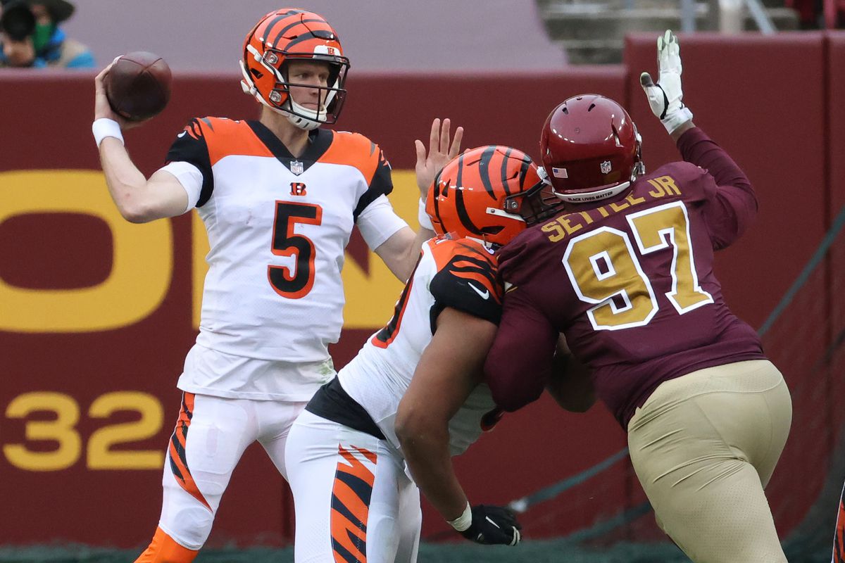 Cincinnati Bengals quarterback Ryan Finley (5) passes the ball under pressure from Washington Football Team nose tackle Tim Settle (97) in the fourth quarter at FedExField.