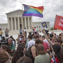 The crowd reacts as the ruling on same-sex marriage was announced outside of the Supreme Court in Washington, Friday June 26, 2015. The Supreme Court declared Friday that same-sex couples have a right to marry anywhere in the US. 