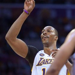 Los Angeles Lakers center Dwight Howard points to the sky after making a free throw during the second half of their NBA basketball game against the San Antonio Spurs, Sunday, April 14, 2013, in Los Angeles. The Lakers won 91-86. 
