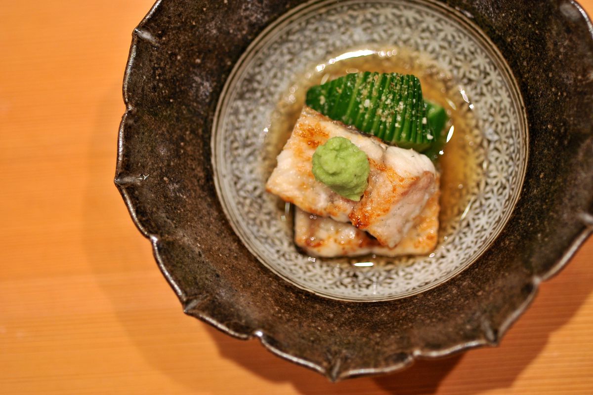 A bowl containing a cooked fish dish 