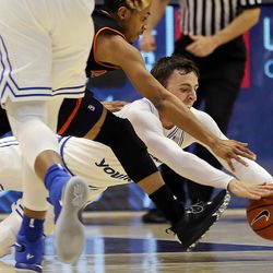 Idaho State Bengals guard Ethan Telfair (3) and Brigham Young Cougars guard Nick Emery (4) dive for a loose ball during NCAA basketball in Provo on Tuesday, Dec. 20, 2016.
