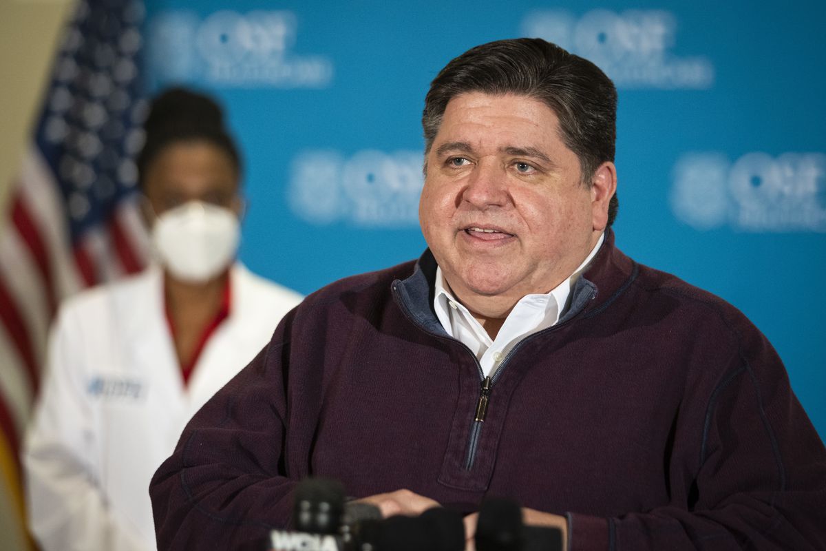 Gov. J.B. Pritzker speaks to reporters at OSF Saint Francis Medical Center in downstate Peoria in December.