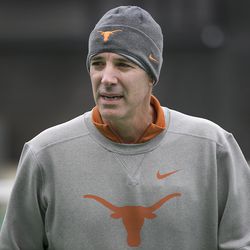 In this January 2018 photo, Texas men’s tennis coach Michael Center surveys the courts before the matches with UTSA, in Austin, Texas. Center is among a few people in the state charged in a scheme that involved wealthy parents bribing college coaches and others to gain admissions for their children at top schools, federal prosecutors said Tuesday, March 12, 2019. (Ralph Barrera/Austin American-Statesman via AP)