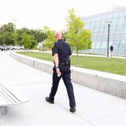 Former Salt Lake City Police Chief Chris Burbank walks adjacent to the Public Safety Building in Salt Lake City after being asked not to return to the building after handing in his resignation at police chief on Thursday, June 11, 2015. 