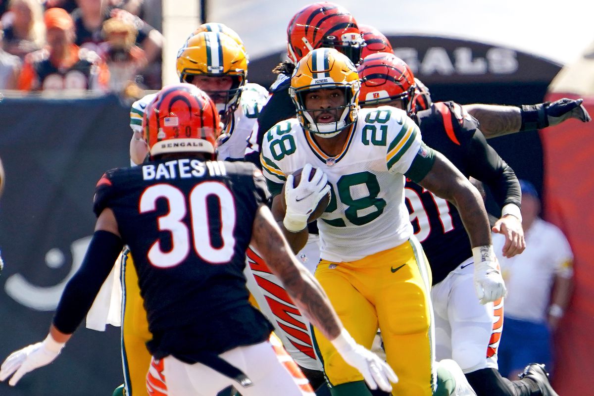 Green Bay Packers running back A.J. Dillon (28) carries the ball as Cincinnati Bengals free safety Jessie Bates (30) looks to make a tackle in the second quarter of a Week 5 NFL football game, Sunday, Oct. 10, 2021, at Paul Brown Stadium in Cincinnati. Green Bay Packers At Cincinnati Bengals Oct 10