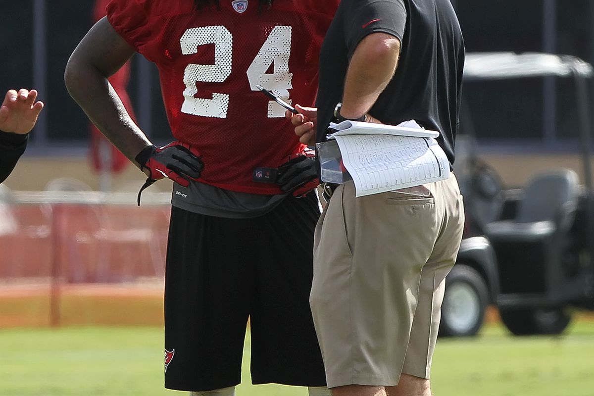 July 27, 2012; Tampa, FL, USA;  Tampa Bay Buccaneers head coach Greg Schiano talks with defensive back Mark Barron (24) during training camp at One Buc Place. Mandatory Credit: Kim Klement-US PRESSWIRE