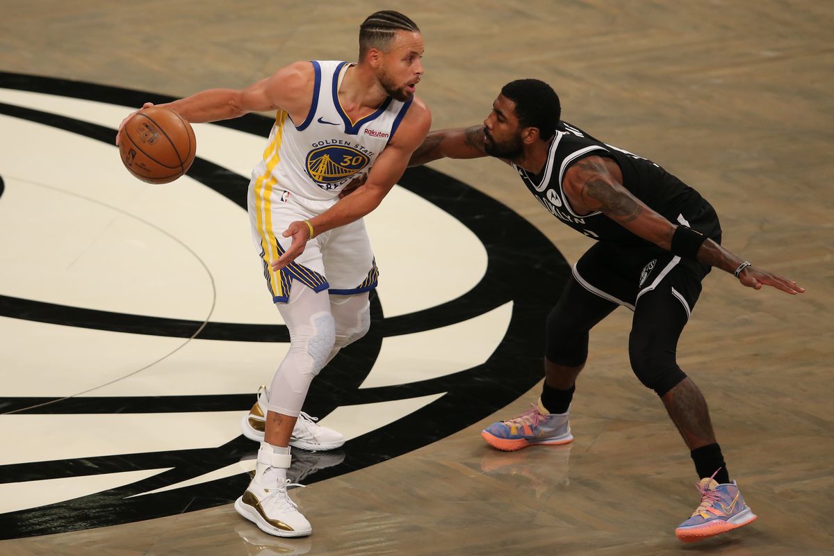 Golden State Warriors point guard Stephen Curry controls the ball against Brooklyn Nets point guard Kyrie Irving during the first quarter at Barclays Center.