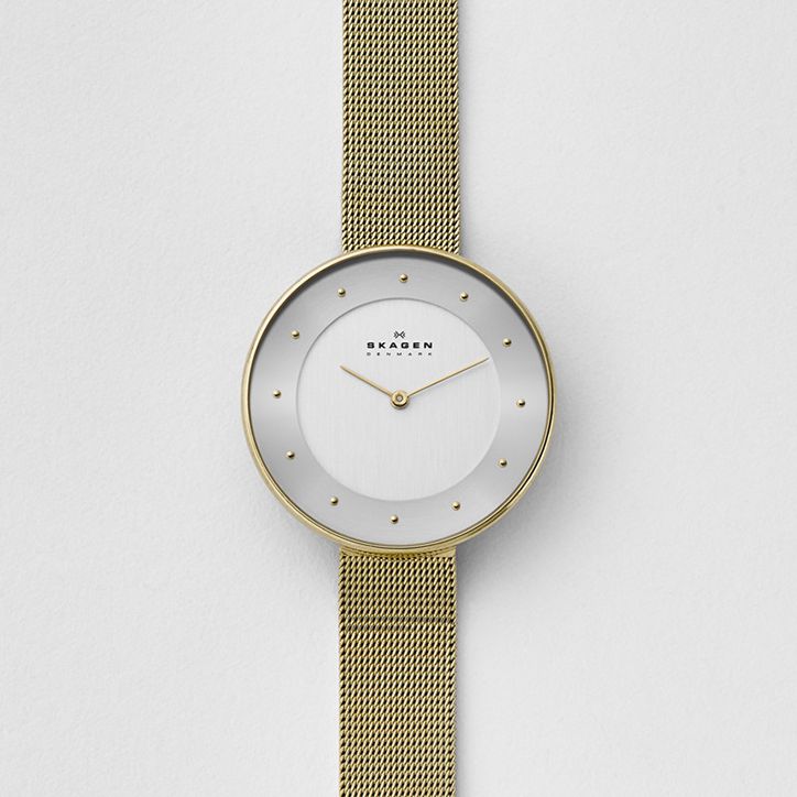 a watch with gold mesh straps