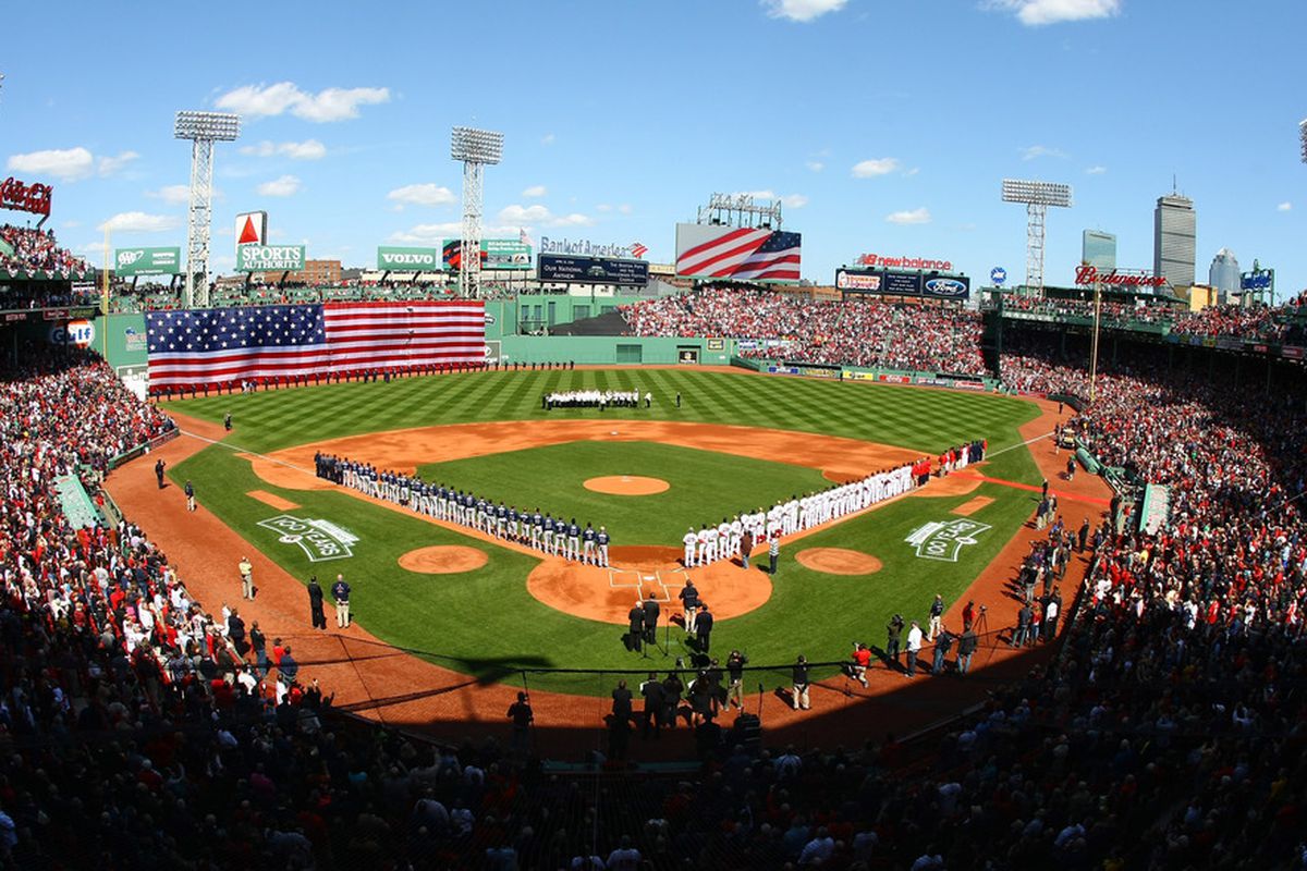 BOSTON, MA - APRIL 13:  The Boston Red Sox and the Tampa Bay Rays line up for the national anthem during the home opener on April 13, 2012 at Fenway Park in Boston, Massachusetts.  (Photo by Elsa/Getty Images)