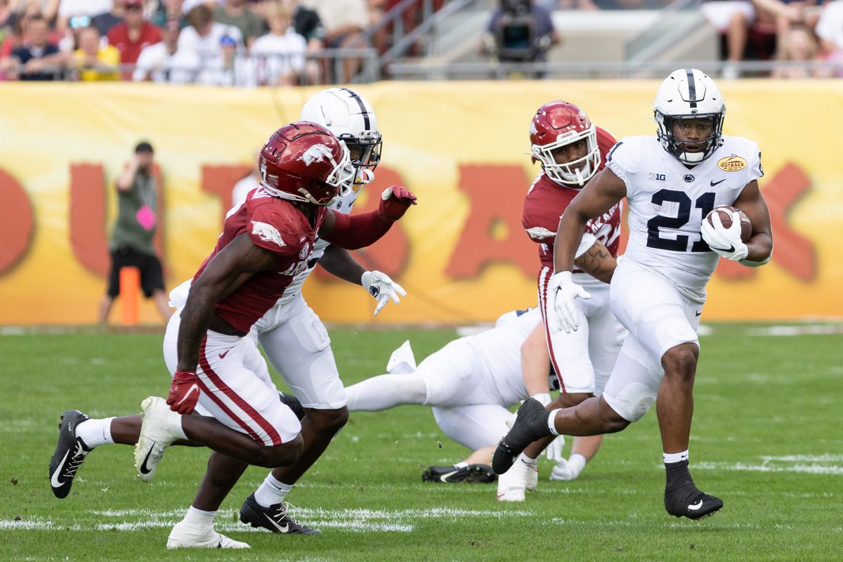 Penn State Nittany Lions running back Noah Cain (21) runs with the ball during the first half against the Arkansas Razorbacks during the 2022 Outback Bowl