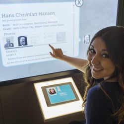 Sister missionary Emily Hansen of McKinney, Texas, points to the screen with information about her ancestor, Hans Hansen, in the new Family Discovery Center in Salt Lake City.
