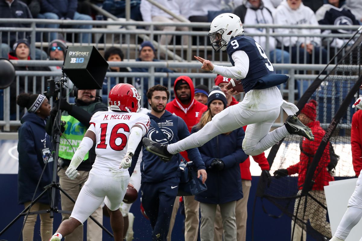 Penn State Nittany Lions quarterback Christian Veilleux (9) leaps into the air to avoid a tackle during the fourth quarter against the Rutgers Scarlet Knights at Beaver Stadium. Penn State defeated Rutgers 28-0.