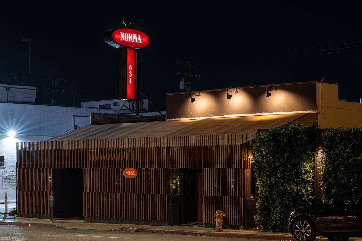 A striking exterior of a West Hollywood restaurant with red signage pylon.