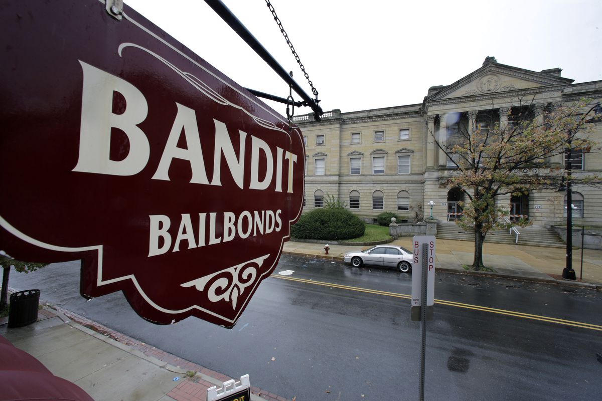 This Oct. 23, 2014 file photo a sign is seen outside a bail bondsman across the street from Mercer County criminal courthouse in Trenton, N.J. (AP Photo/Mel Evans,File)